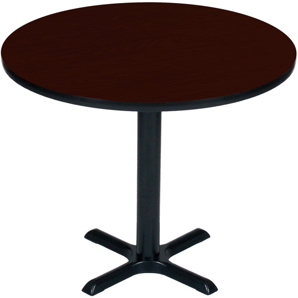 A Correll round mahogany bar height table with a black base.