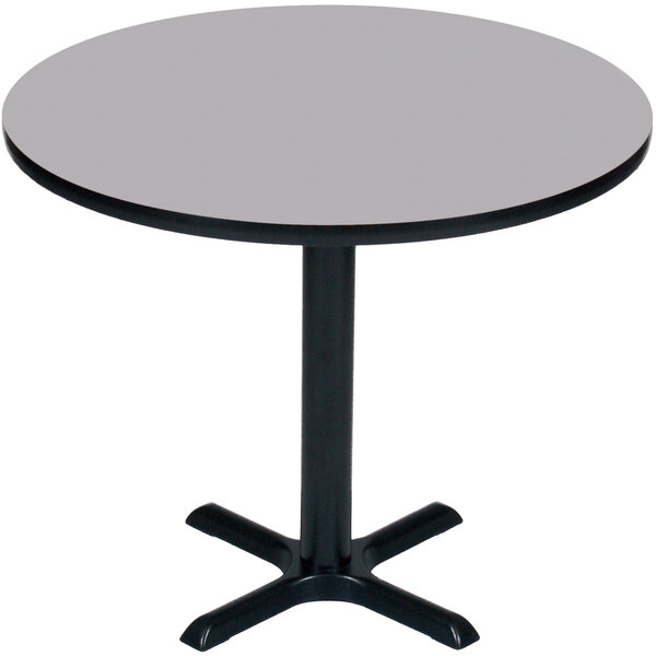 A Correll round bar height table with a gray granite top and black base.
