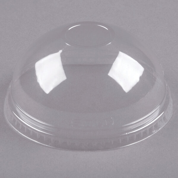 A clear plastic Dart Conex dome lid on a clear plastic container.