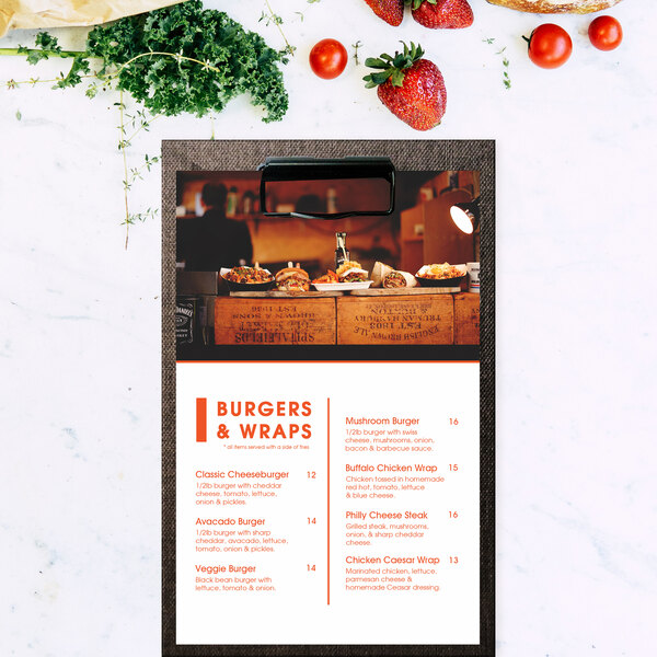 A customizable menu clipboard with a vinyl wrap featuring a burger and vegetable menu.