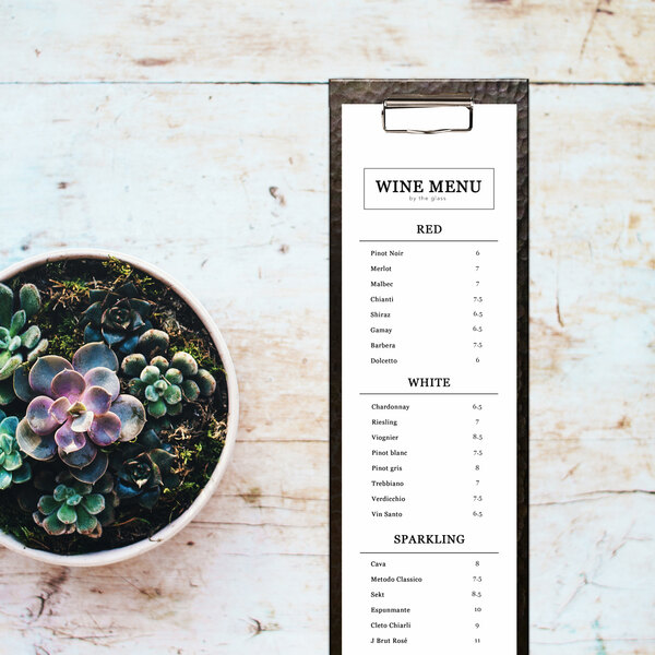 A potted succulent plant next to a Gatsby menu clipboard with vinyl wrap.