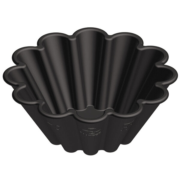 A black plastic Matfer Bourgeat mini fluted brioche mold with scalloped edges.