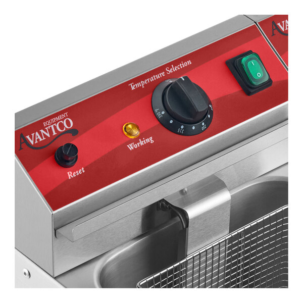 A close-up view of a stainless steel appliance control panel with a temperature selection dial, reset button, indicator light, and power switch.