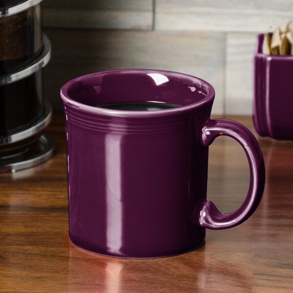 A purple Fiesta java mug on a wooden table.