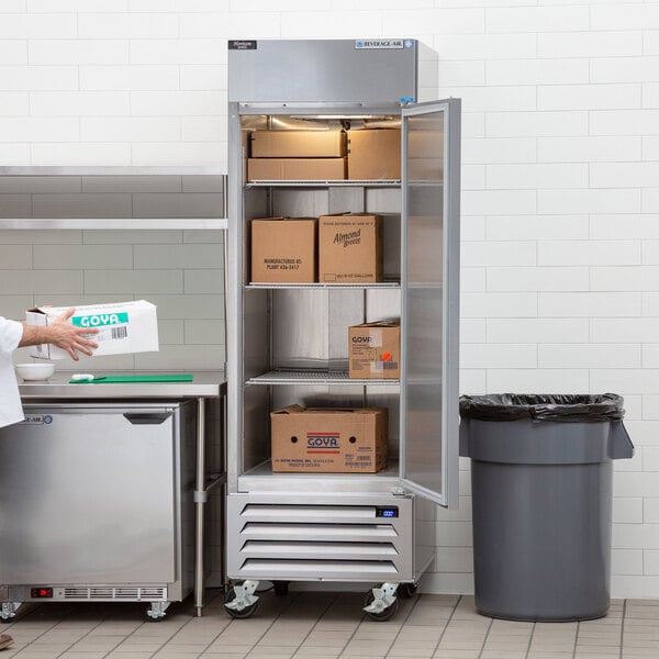 A woman standing in front of a Beverage-Air Horizon Series reach-in freezer.