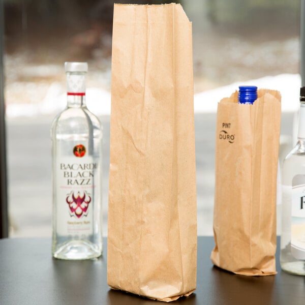A close-up of a Duro brown paper bag with bottles inside.