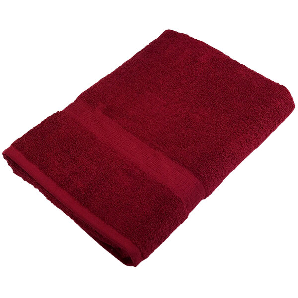 A Monarch Brands burgundy bath towel.