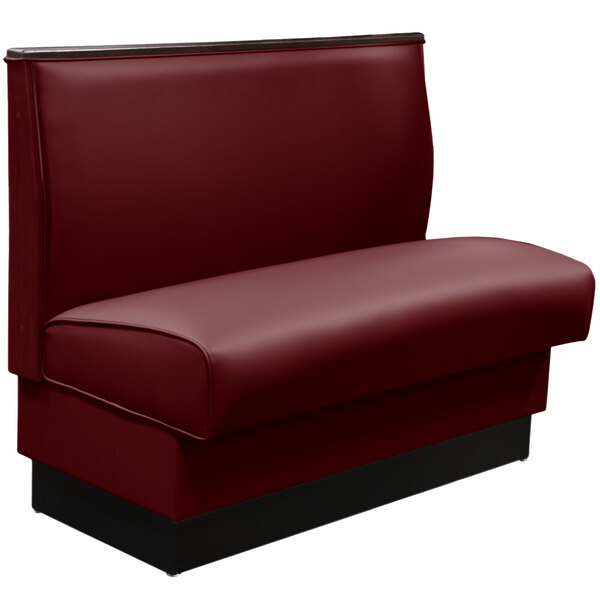 A red leather booth seat with black wood trim.