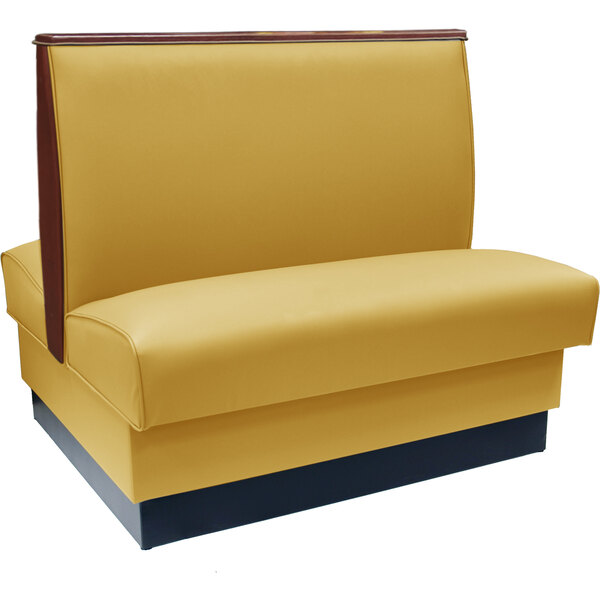 An American Tables & Seating double booth upholstered in yellow with brown trim.
