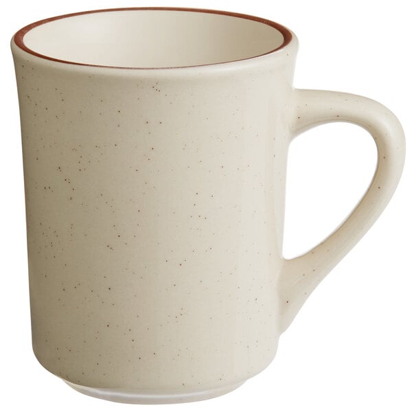 A white stoneware mug with a brown band on the rim.