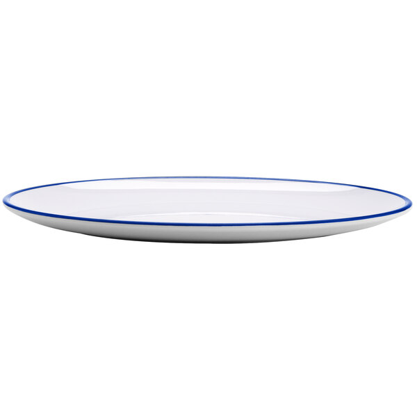 A white oval melamine dinner plate with a blue rim.