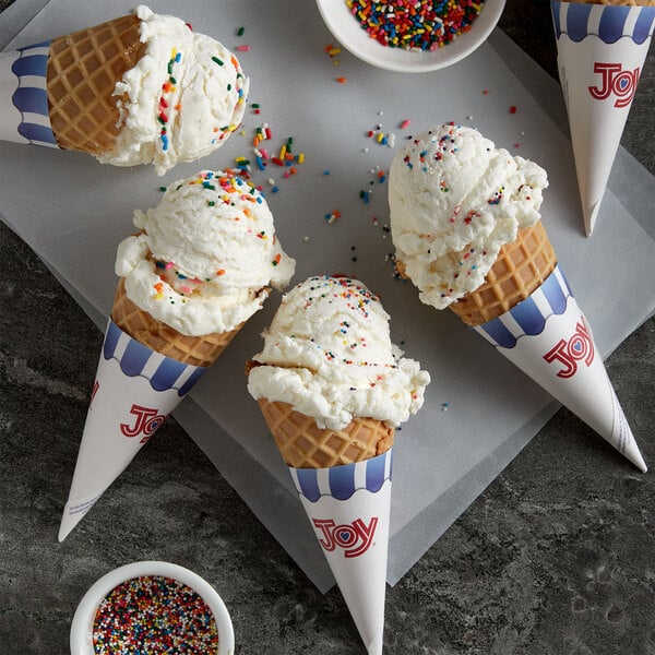 A JOY waffle cone filled with ice cream and sprinkles.