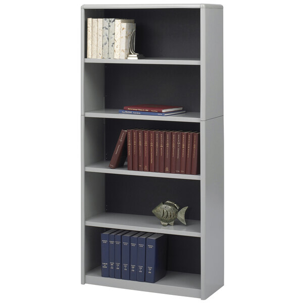 A grey Safco ValueMate bookcase with books and a fish figurine on a shelf.
