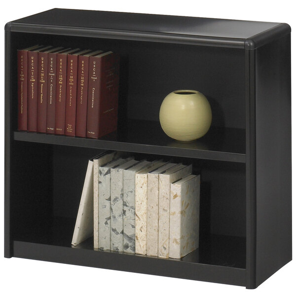 A black Safco ValueMate bookcase with books and a vase on it.
