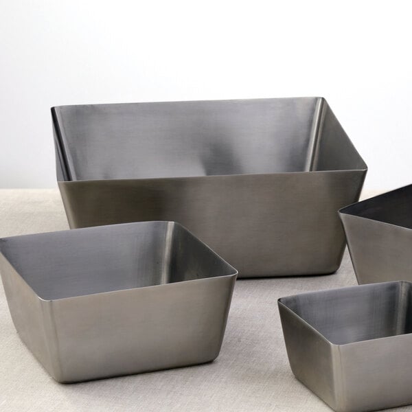 Three American Metalcraft stainless steel square bowls on a table.