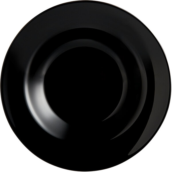 An Arcoroc black opal glass pasta plate with a white background.