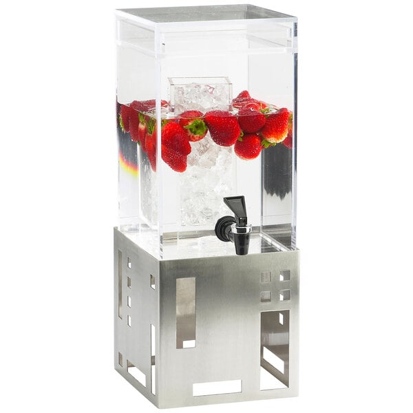 A Cal-Mil stainless steel beverage dispenser with ice chamber on a white background filled with water and strawberries.