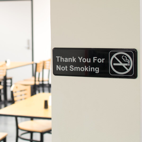 A black and white rectangular sign that says "Thank You For Not Smoking" by Thunder Group.