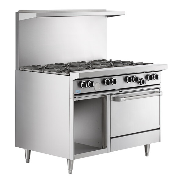 A large stainless steel U.S. Range commercial gas range with 4 burners, a 24" manual griddle, and a cabinet base.