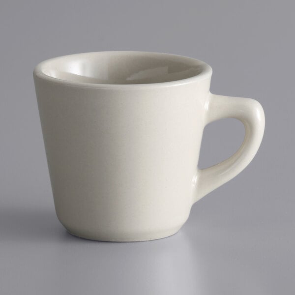 A Libbey white stoneware cup with a handle.