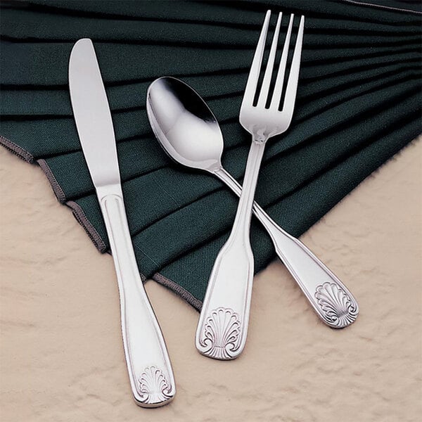 A Libbey stainless steel dinner fork on a napkin.