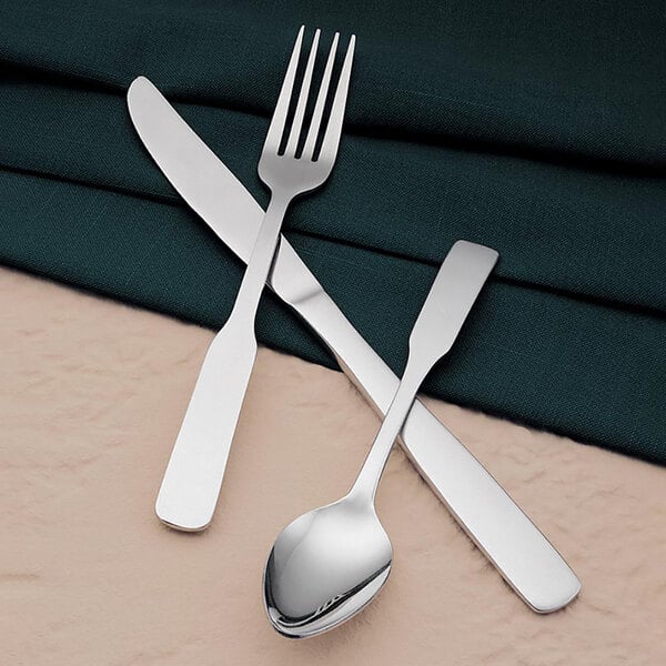 A stainless steel knife and fork on a napkin.