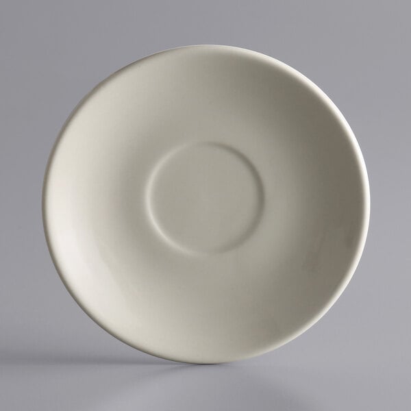 A Libbey white stoneware saucer with a small rim around the edge.