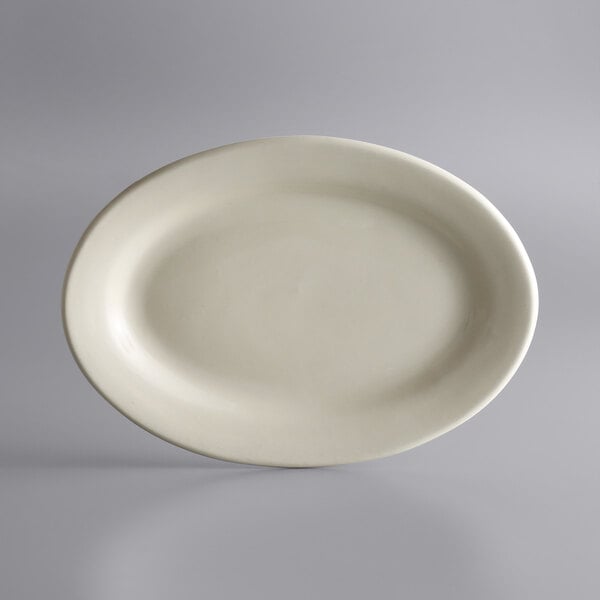 A white oval Libbey stoneware platter with a rolled edge on a gray background.