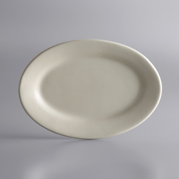 A white oval Libbey stoneware platter on a gray surface.