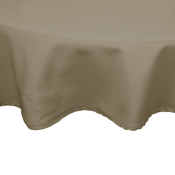 A beige Intedge cloth table cover on a round table.
