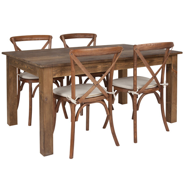 A Flash Furniture rustic wooden farm table with four chairs and white cushions.