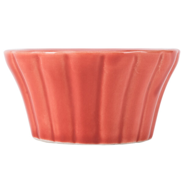 A close up of a CAC red floral ramekin with a white background.