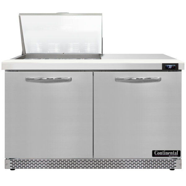 A stainless steel Continental Refrigerator with two open doors and a lid open.