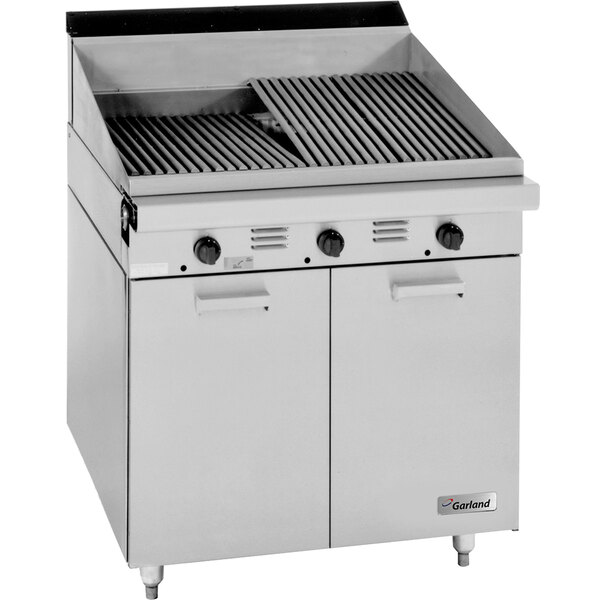 A large stainless steel Garland charbroiler with storage base and piezo ignition.