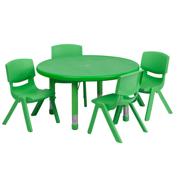 A green plastic table with four green chairs.