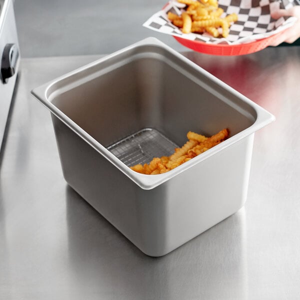 A Choice stainless steel steam table pan with french fries on a counter.