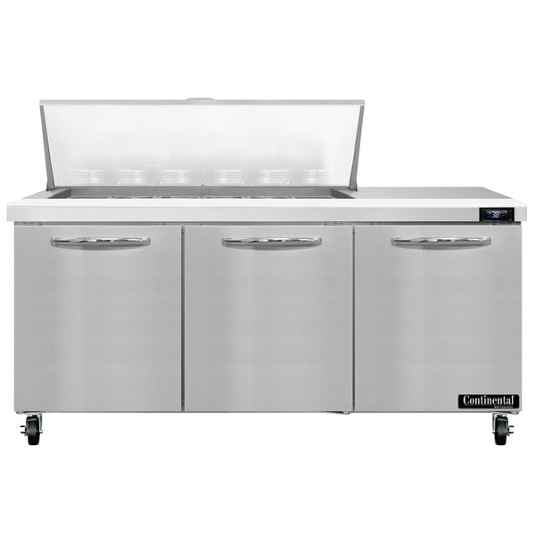 A stainless steel Continental Refrigerator with three doors and a lid on a counter.