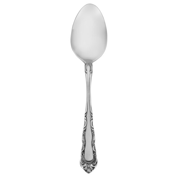 A close-up of a Walco Patrician stainless steel serving spoon with a pattern on it.