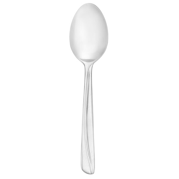 A Walco stainless steel dessert spoon with a scroll design on the handle.