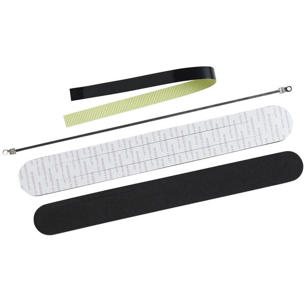 A black rectangular object with a pair of black and white strips and a green strip.
