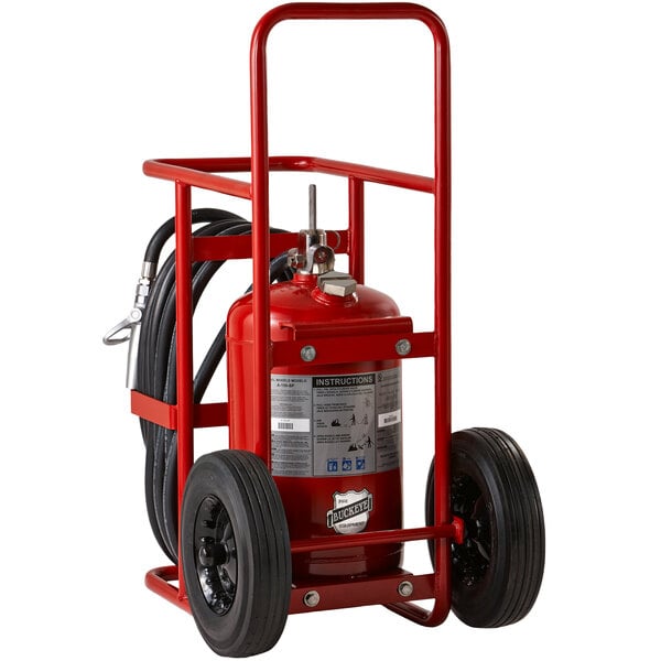 A Buckeye red fire extinguisher stored on a cart with rubber wheels.