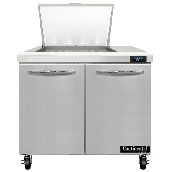 A stainless steel Continental Refrigerator with two doors open on a counter.