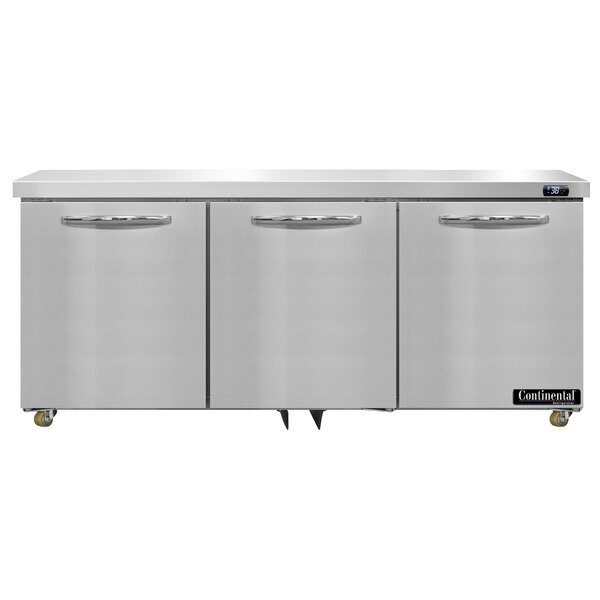 A stainless steel Continental Refrigerator with three doors on a white countertop.