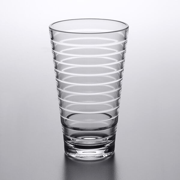 A clear plastic mixing glass with a spiral pattern.