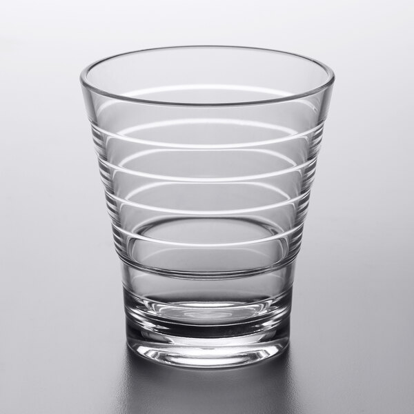 A clear GET Cirq rocks glass with a curved design.