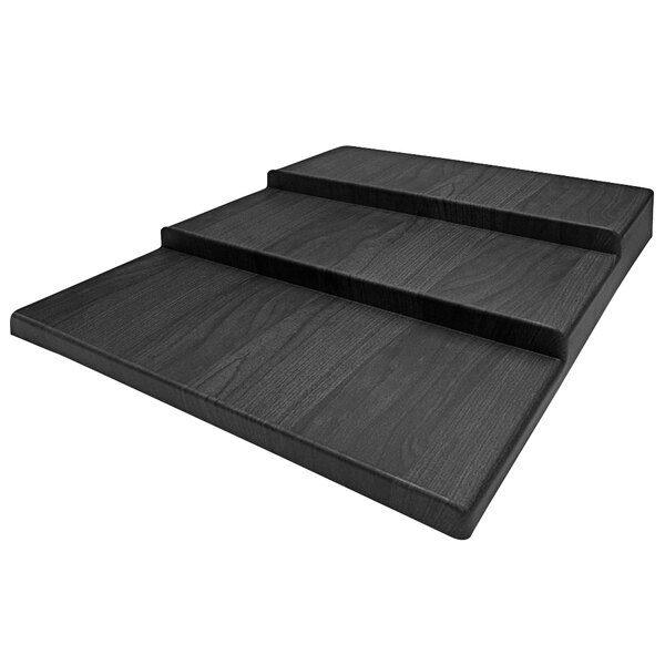 A black wood shelf with three steps.