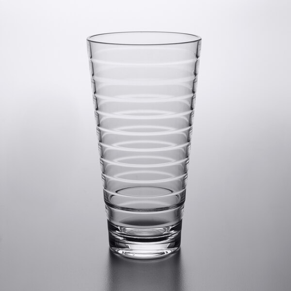 A clear plastic mixing glass with a curved pattern.