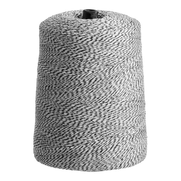A large cone of black and white variegated polyester cotton blend baker's twine.