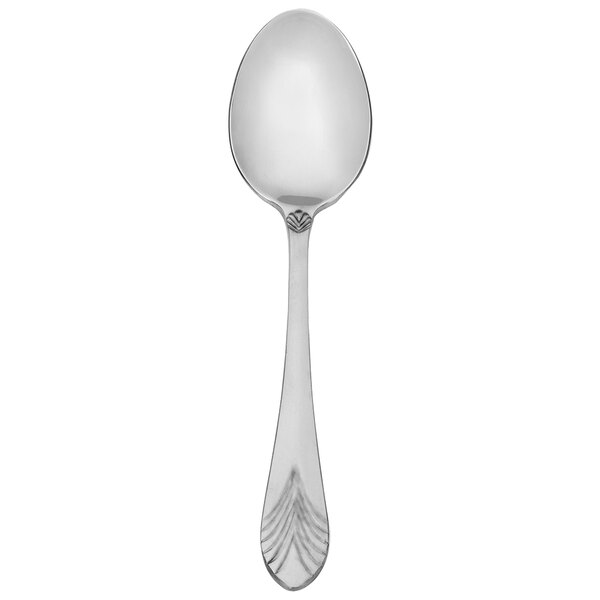 A close-up of a Walco stainless steel dessert spoon with a design on the handle.