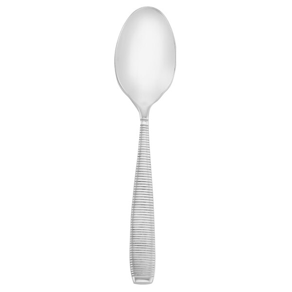 A silver Walco stainless steel dessert spoon with a white handle.